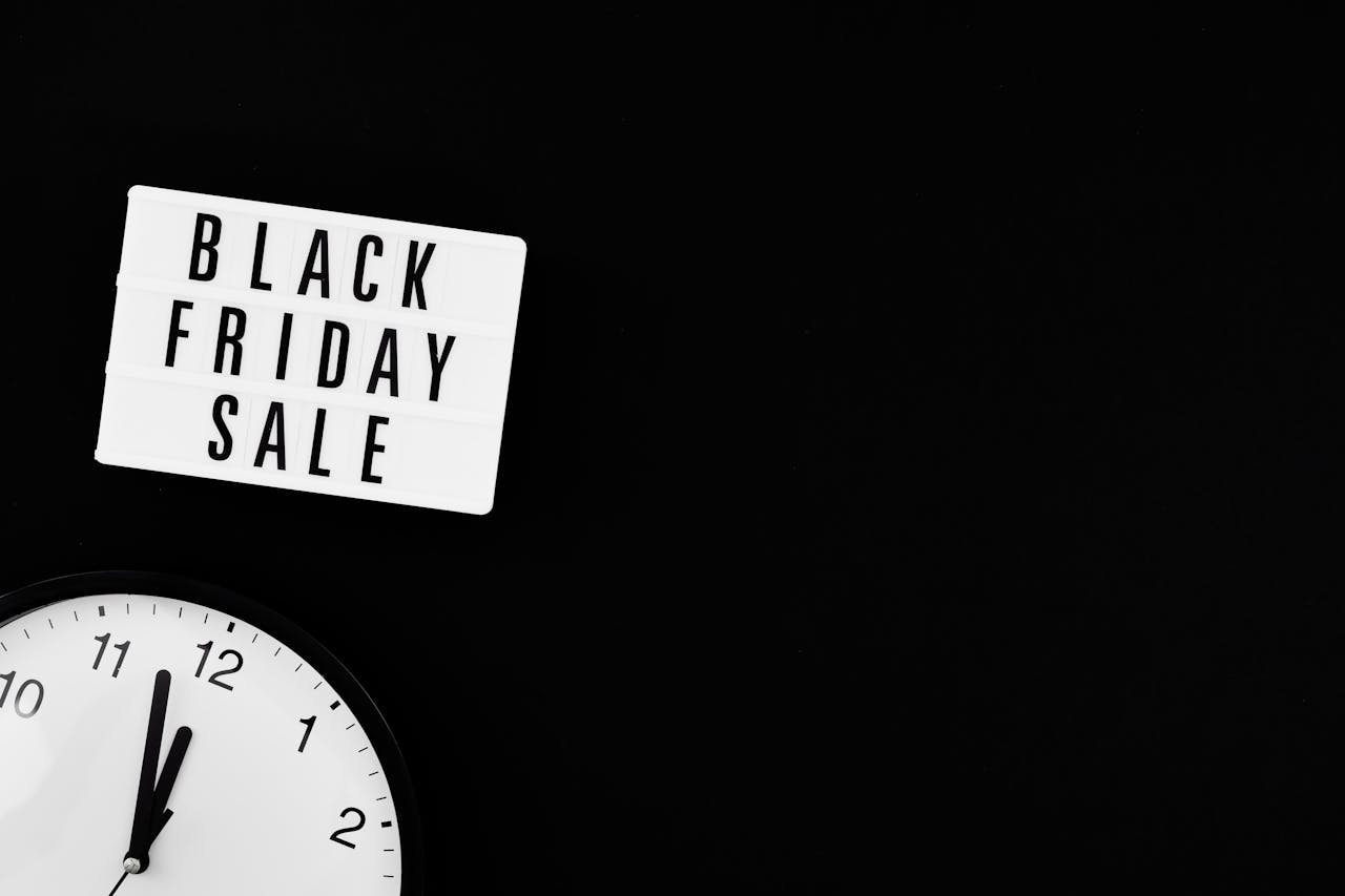 Minimalist Black Friday sale sign with clock on black background for promotions.