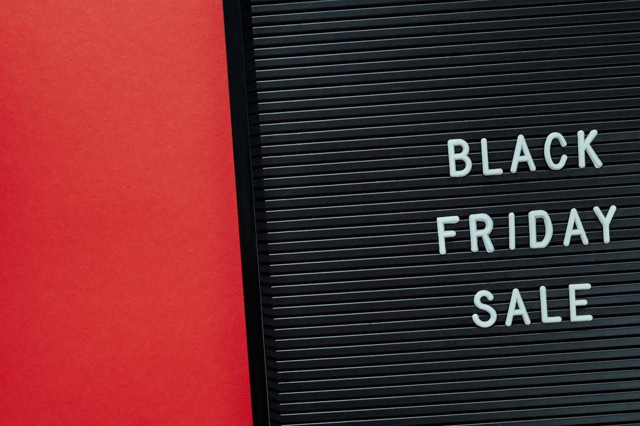 Minimalist Black Friday sale sign on a red background offering copy space for promotional use.